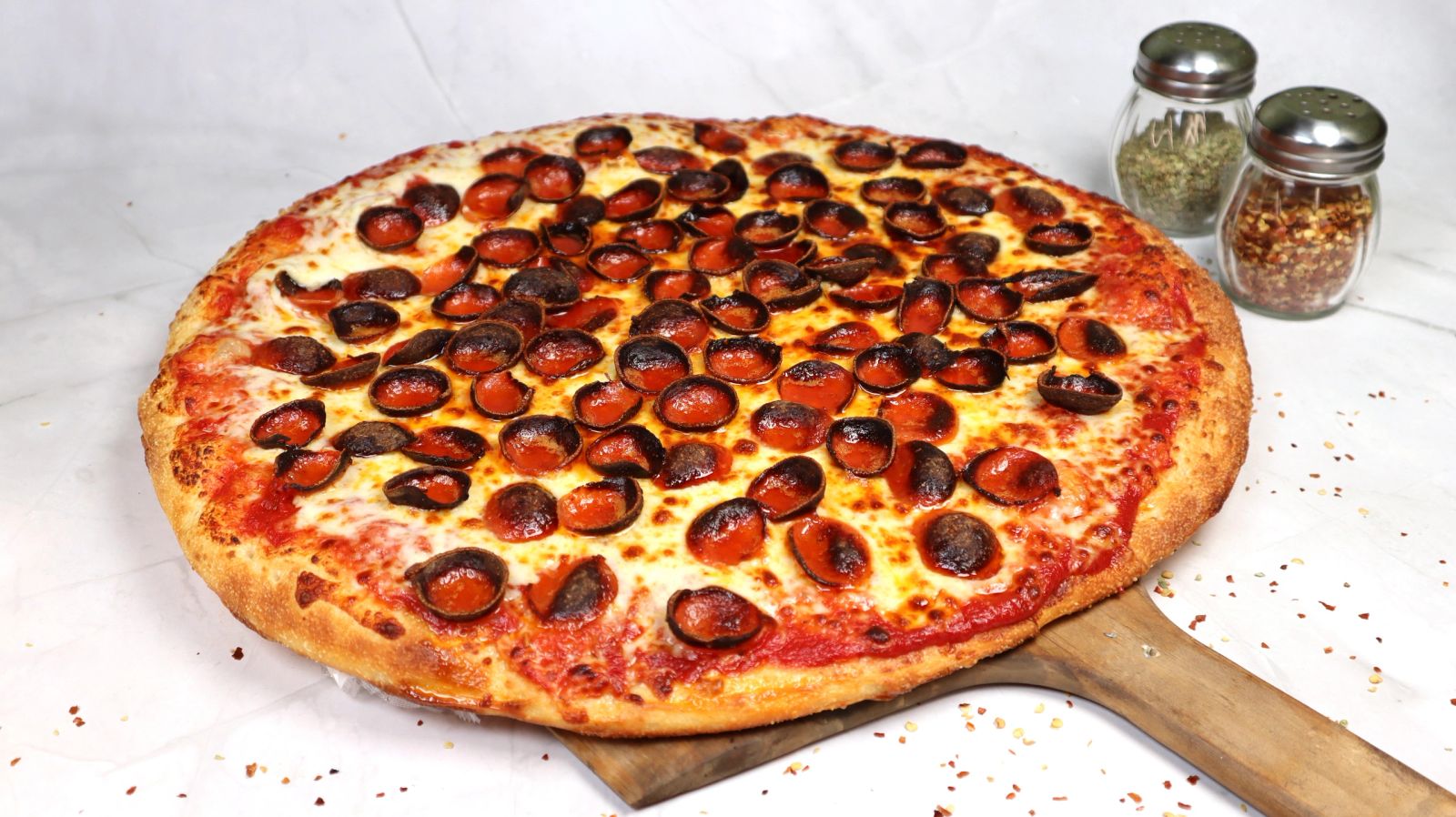 A hand-tossed cup-and-char pepperoni pizza, fresh from the oven at Pizza Delizia