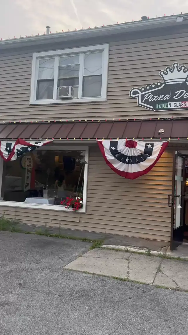 The Pizza Delizia storefront on Bowen Road, decked out with flag bunting and string lights