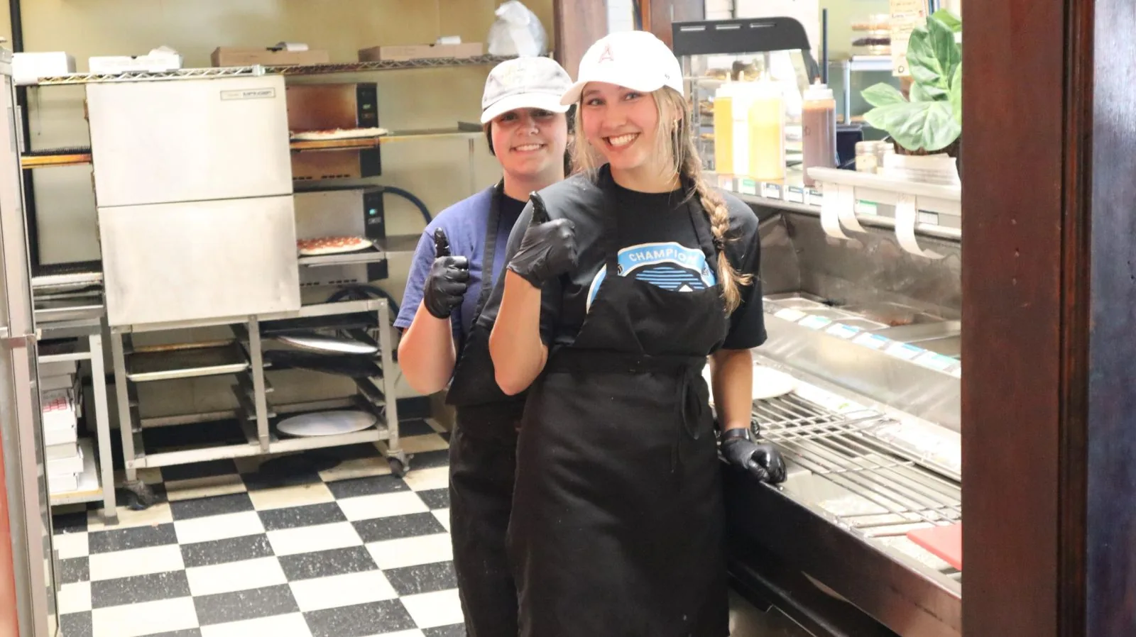 The Pizza Delizia family behind the counter